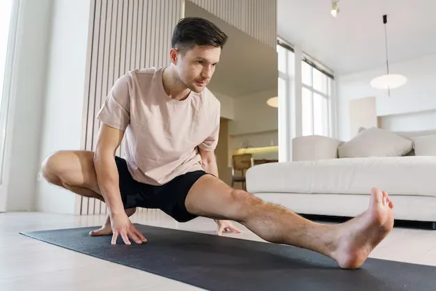 Person performing a gentle stretching sequence on a yoga mat